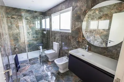 a bathroom with a sink toilet and a mirror at Casa do Beco do Barlavento in Vila Baleira