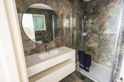 a bathroom with a sink and a mirror at Casa do Beco do Barlavento in Vila Baleira