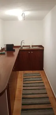 a kitchen with a counter with a sink and a rug at Casa Gama in Ribeira da Janela