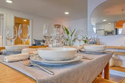 a table with bowls and wine glasses on it at Vale dos Amores, a Home in Madeira in Calheta