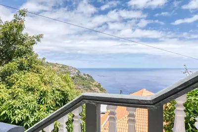 a balcony with a view of the ocean at Vale dos Amores, a Home in Madeira in Calheta