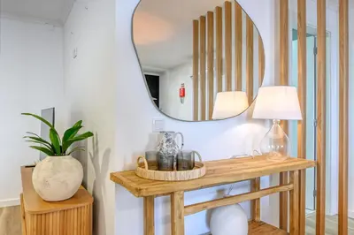 a mirror on a wall next to a table at Vale dos Amores, a Home in Madeira in Calheta