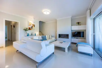 a white living room with a white couch and chairs at Boa Vista - Golf View Villa in Lagos