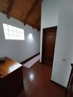 an empty room with a door and a window at Palheiro do Farrobo in Porto Moniz