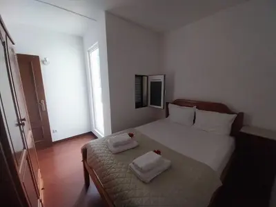 a bedroom with a bed with two towels on it at Palheiro do Farrobo in Porto Moniz