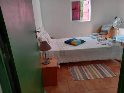 a bedroom with a bed and a lamp and a window at Casa da Oliveira - Nice 2 bedrooms Bungalow in Lagos in Lagos