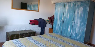 a bedroom with a bed and a blue wooden cabinet at Casa da Oliveira - Nice 2 bedrooms Bungalow in Lagos in Lagos