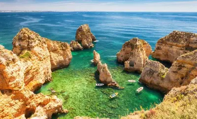 a group of rocks in the water near the ocean at Casa da Oliveira - Nice 2 bedrooms Bungalow in Lagos in Lagos