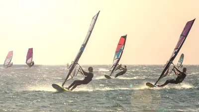 a group of people windsurfing in the ocean at Casa da Oliveira - Nice 2 bedrooms Bungalow in Lagos in Lagos