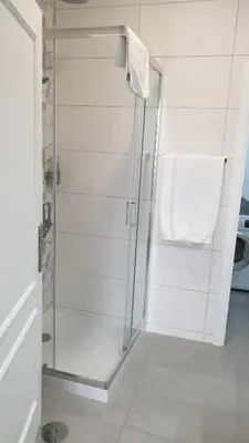 a bathroom with a shower with a white towel at RC Flats Funchal A in Funchal