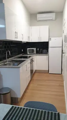 a kitchen with white cabinets and a white refrigerator at RC Flats Funchal A in Funchal