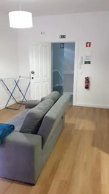 a couch in a living room with a wooden floor at RC Fltas Funchal B in Funchal