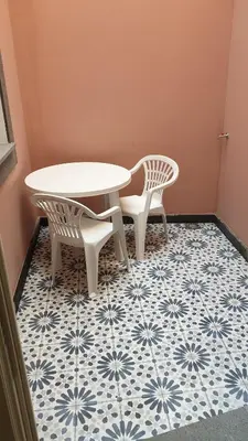 a table and two chairs on a blue and white tile floor at RC Fltas Funchal B in Funchal