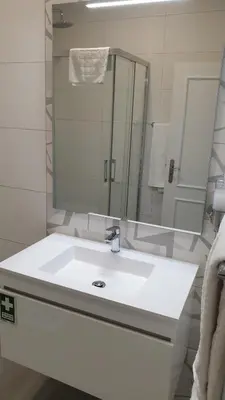a bathroom with a white sink and a mirror at RC Fltas Funchal B in Funchal