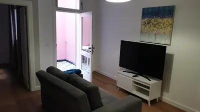 a living room with a couch and a flat screen tv at RC Fltas Funchal B in Funchal