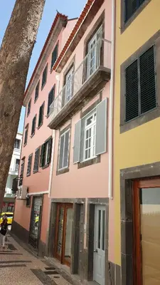 a pink and yellow building on a street at RC Flats Funchal D in Funchal