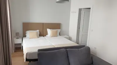 a bedroom with a bed and a couch at RC Fltas Funchal C in Funchal