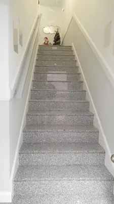 a staircase with grey carpeting and a christmas tree at RC Fltas Funchal C in Funchal