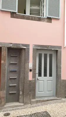 a pink building with a door and a window at RC Fltas Funchal C in Funchal