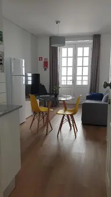 a living room with a couch and a table and chairs at RC Fltas Funchal C in Funchal
