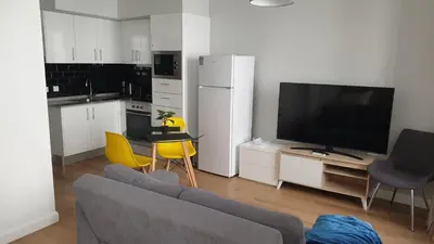 a living room with a couch and a flat screen tv at RC Fltas Funchal C in Funchal
