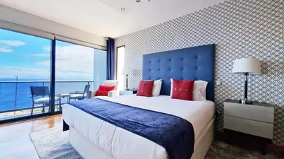 a bedroom with a large bed with a blue headboard at Azure Serenity Villa by LovelyStay in Santa Cruz