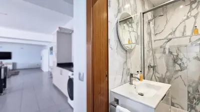 a bathroom with a sink and a mirror at Azure Serenity Villa by LovelyStay in Santa Cruz