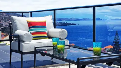 a living room with a couch and a glass table at Azure Serenity Villa by LovelyStay in Santa Cruz