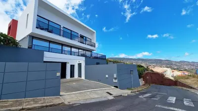 a house on a hill with a driveway at Azure Serenity Villa by LovelyStay in Santa Cruz