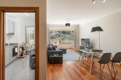 a kitchen and living room with a table and chairs at Green Park by An Island Apart in Funchal