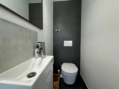 a bathroom with a white toilet and a sink at Luz Vila in Luz