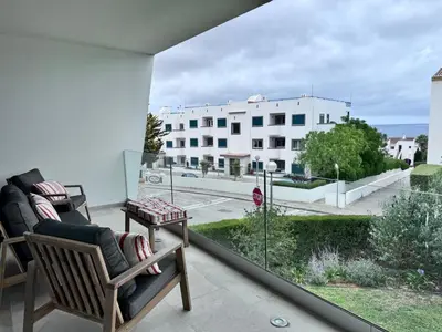 a balcony with chairs and a view of a building at Luz Vila in Luz