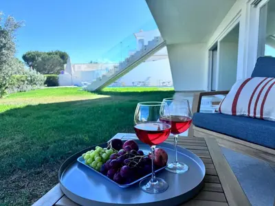 two glasses of wine and a plate of fruit on a table at Luz Vila in Luz