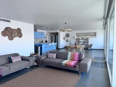a living room with two couches and a kitchen at Luz Vila in Luz