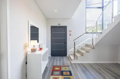 a hallway with a blue door and stairs at Paradise Pereira House BY YOUR KEY MADEIRA in Calheta