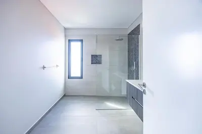 a white bathroom with a shower and a glass door at Paradise Pereira House BY YOUR KEY MADEIRA in Calheta