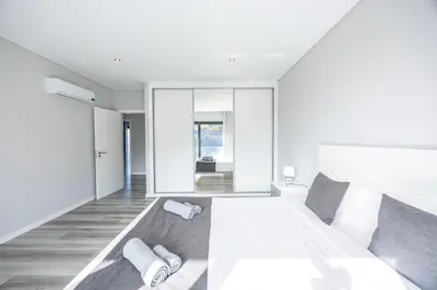 a bedroom with a large bed with pillows on it at Paradise Pereira House BY YOUR KEY MADEIRA in Calheta