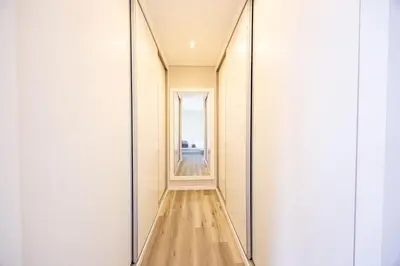 a hallway with mirrors and a wooden floor at Paradise Pereira House BY YOUR KEY MADEIRA in Calheta