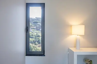 a window in a room with a lamp next to it at Paradise Pereira House BY YOUR KEY MADEIRA in Calheta
