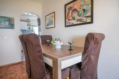 a dining room with a wooden table and chairs at Casa dos Zefiros in Luz