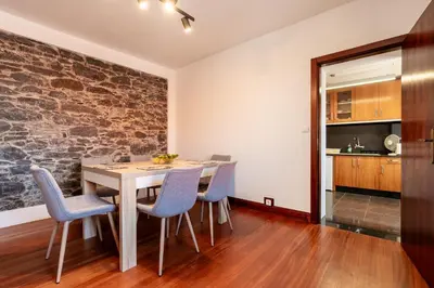 a kitchen and dining room with a table and chairs at Casa Silva, Calheta in Calheta