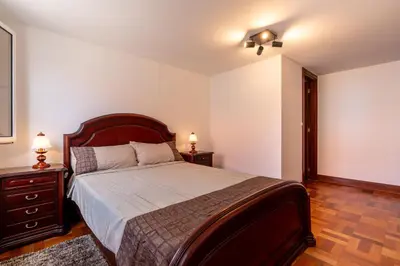 a bedroom with a large bed and two night stands at Casa Silva, Calheta in Calheta