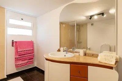 a bathroom with a sink and a large mirror at Casa Silva, Calheta in Calheta