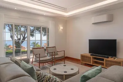 a living room with a couch and a flat screen tv at OurMadeira - Bellissima in Estreito da Calheta