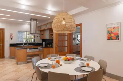 a kitchen and dining room with a table and chairs at OurMadeira - Bellissima in Estreito da Calheta