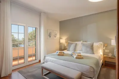 a bedroom with a large bed and a large window at OurMadeira - Bellissima in Estreito da Calheta