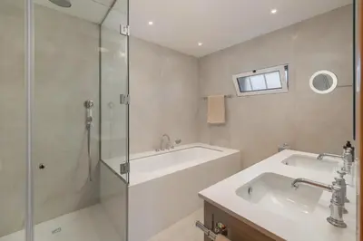 a bathroom with a tub and a sink and a shower at OurMadeira - Bellissima in Estreito da Calheta