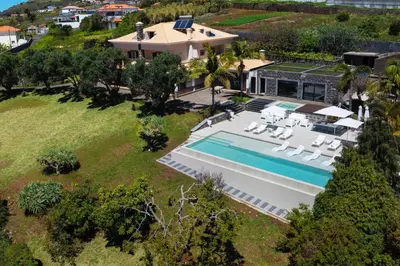 an aerial view of a house with a swimming pool at OurMadeira - Bellissima in Estreito da Calheta