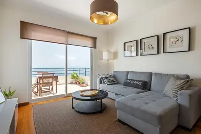 a living room with a couch and a table at VeBella Ocean View in Caniço
