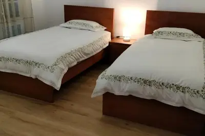 two beds sitting next to each other in a bedroom at Casa Neto Jardim in Calheta